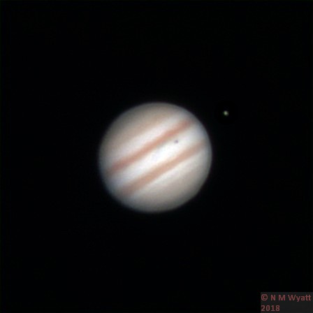 Jupiter and the moon Io, casting its shadow on the gas giant.